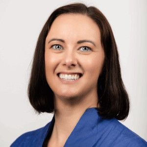 Laura Grant wearing a blue shirt, smiling at the camera.