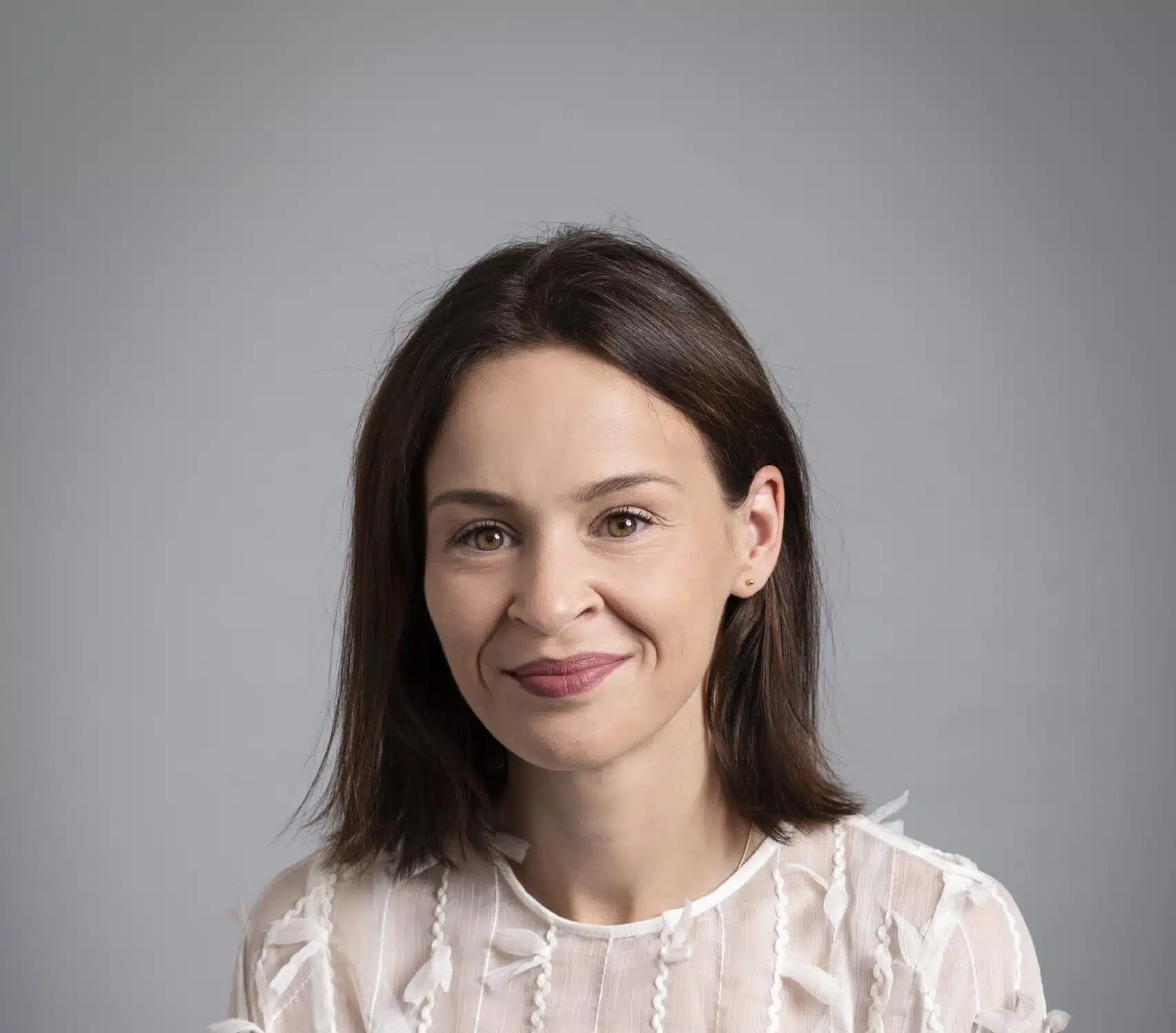 Kate Russell, woman wearing white blouse with dark hair and brown eyes